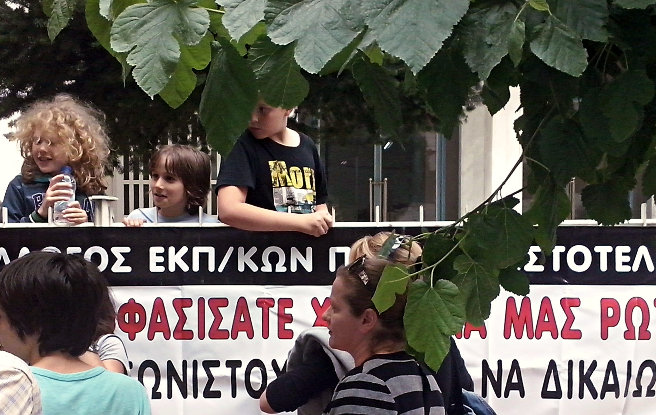 Protesters over the closure and merging of primary schools in Athens. The placard reads: "You've decided without asking for our opinion."